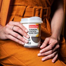 Nona Lim Turmeric Chicken Cup in hand